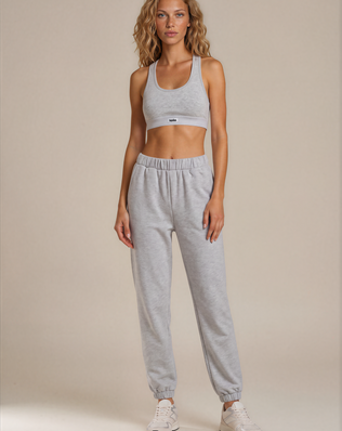 teysha organic cotton sports bra in white, on model with grey track pants