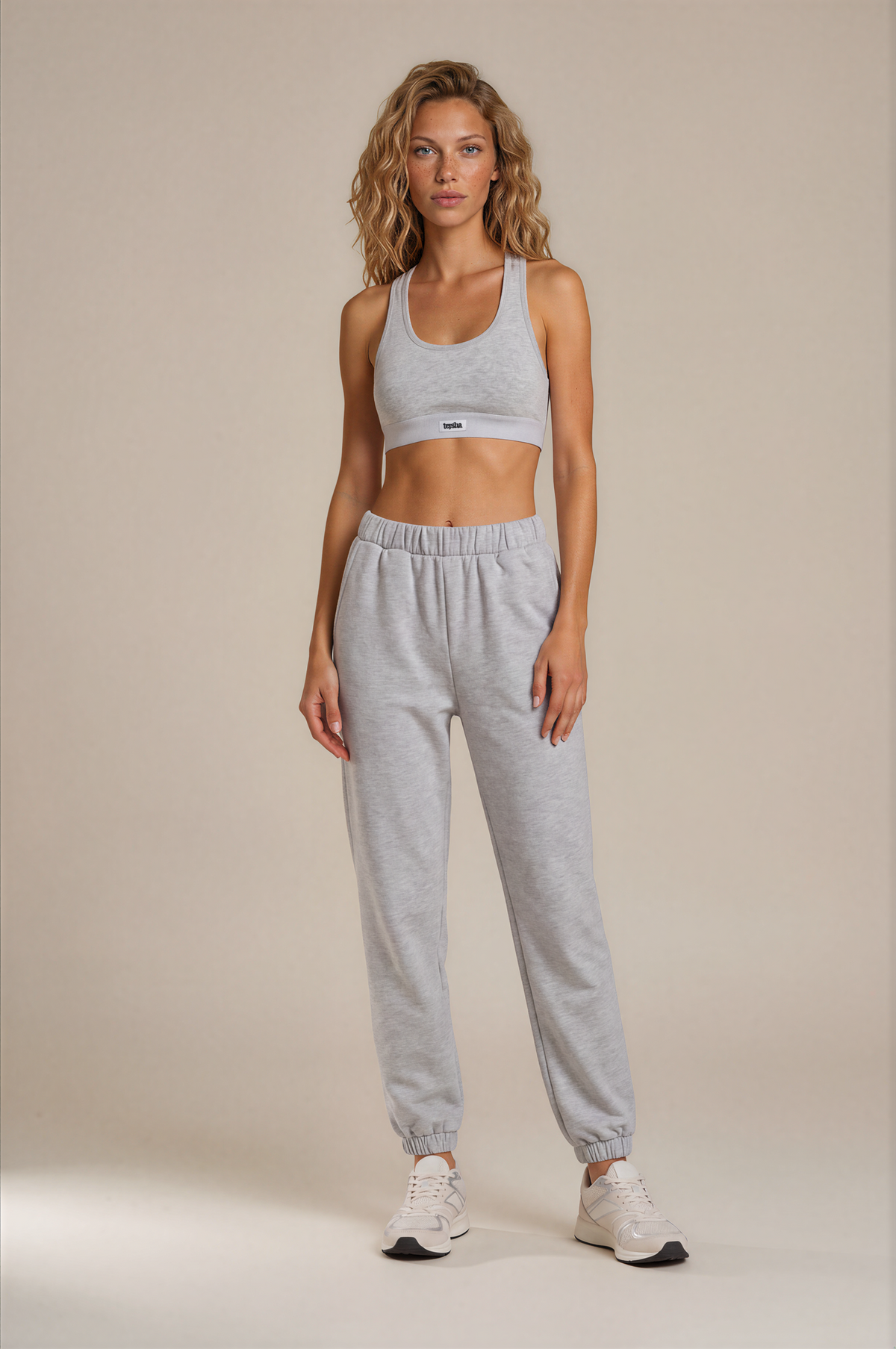 teysha organic cotton sports bra in white, on model with grey track pants