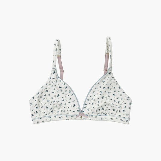 Teysha organic cotton triangle bra in ditsy floral print, front view flat lay — wire-free, Teysha logo band, GOTS-certified first bra for tween girls