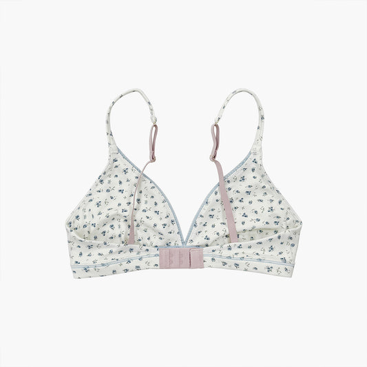 Teysha organic cotton triangle bra in ditsy floral print, flat lay back view — adjustable straps, clasp closure, wire-free, GOTS-certified first bra for tween girls