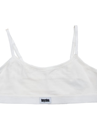White sports bra with thin straps on a white background