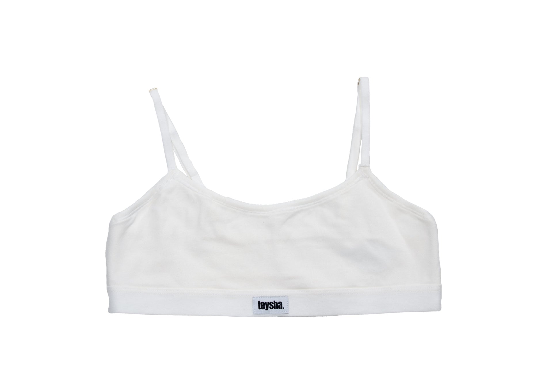 White sports bra with thin straps on a white background